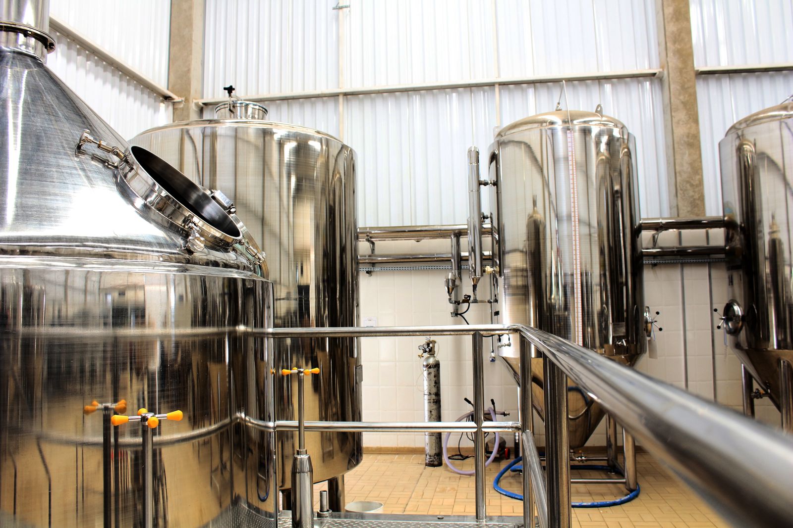Large stainless-steel fermentation tanks in an industrial food production facility